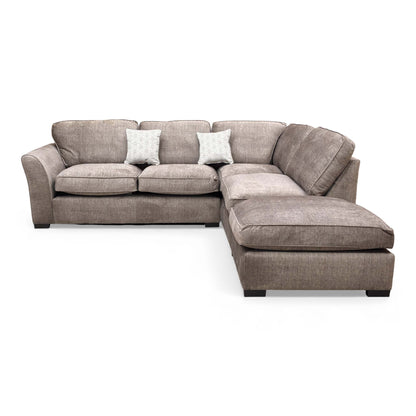 Angled view of the ‘Rosie’ Stone Grey Vogue Velvet Corner Sofa showing the cushions.