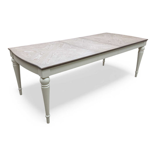 Full view of the Annecy 180cm Extending Dining Table with soft grey painted base and oak veneer top.