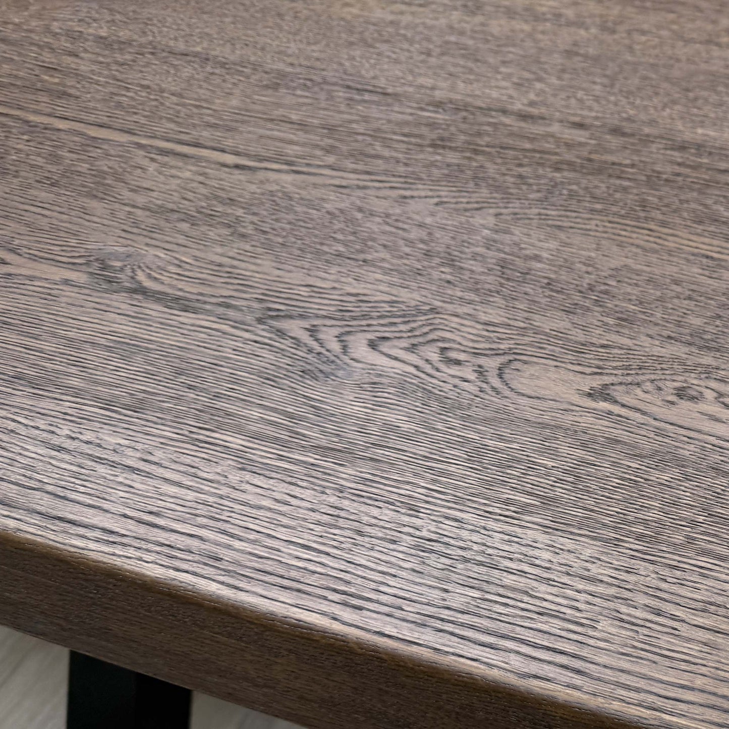 Close-up view of the table's dark metal legs/base.