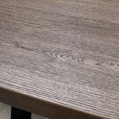 Close-up view of the table's dark metal legs/base.