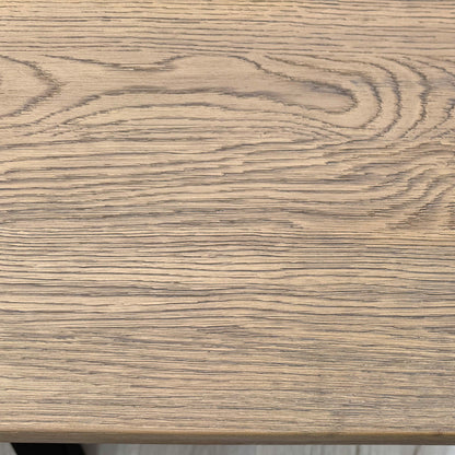 'Saturn' Solid Oak Compact 135cm Fixed Dining Table, three-quarter view on a white background