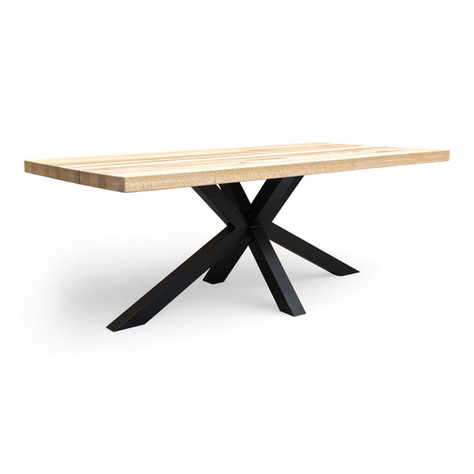 Wide view of the Bodahl Terra dining table showcasing the Natura Bianca solid oak top and black star base.