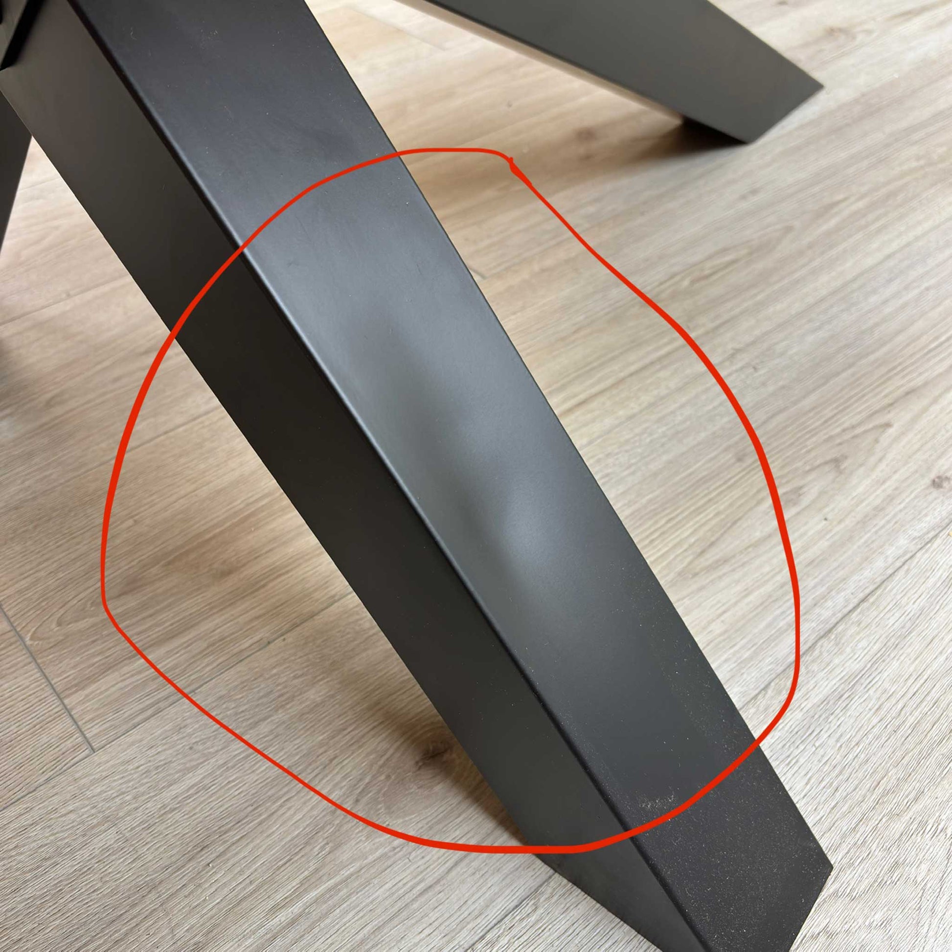 Close-up photo showing the small, shallow dent on the metal base as mentioned in the product notes.