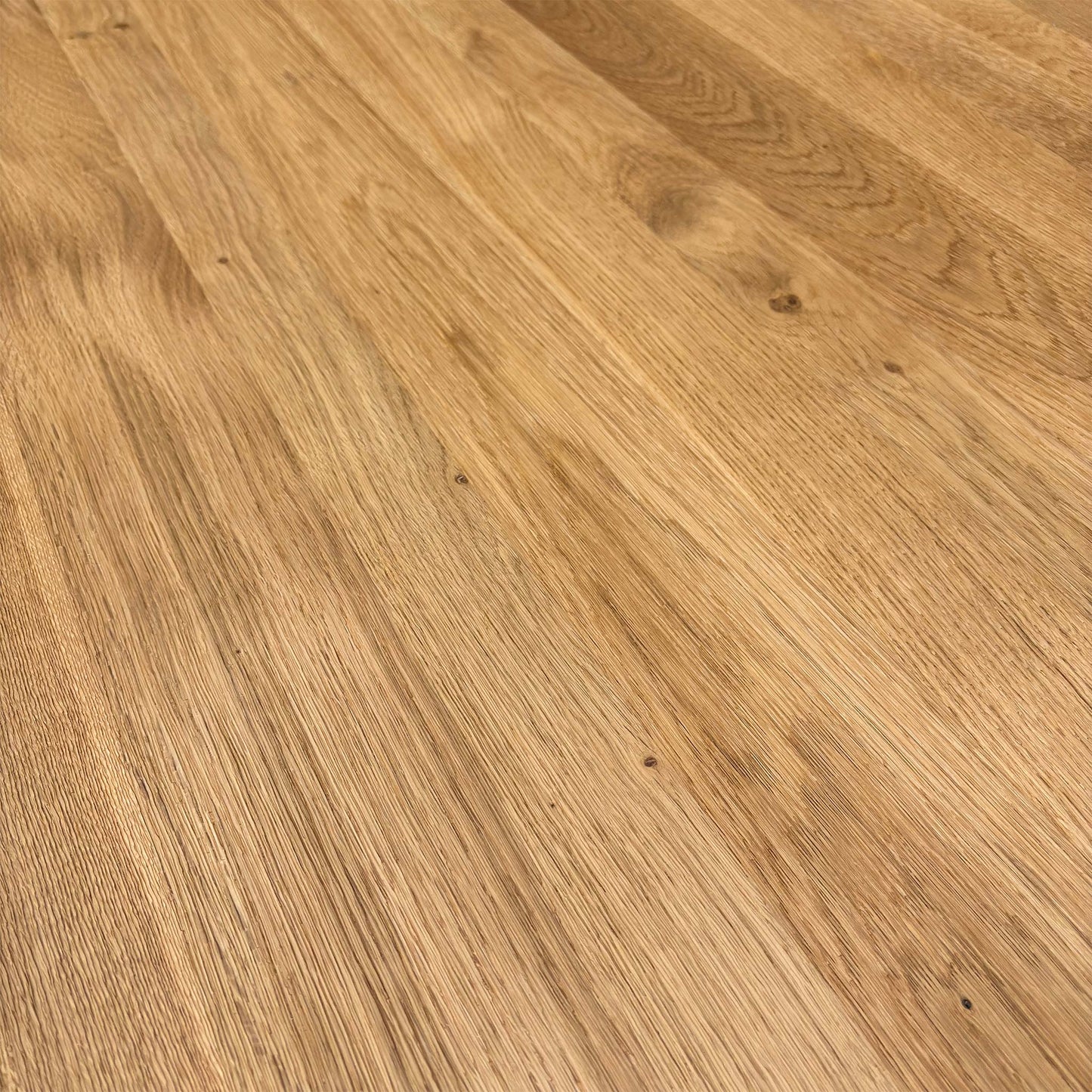 Close-up of the grey powder-coated metal X-leg joining the solid oak table top.