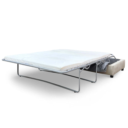 Action shot showing the footstool partially opened to reveal the hidden bed mechanism inside.