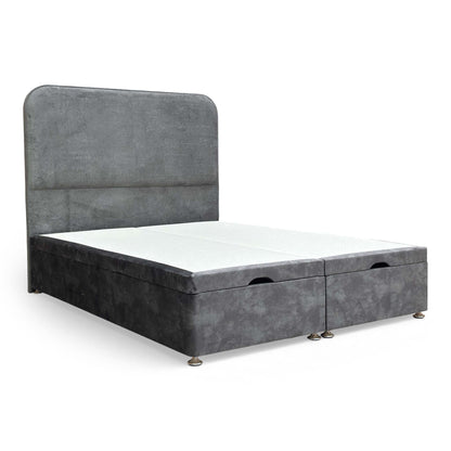 Full shot of the King size Highgrove Pluto bed, showing the dark Domino velvet floor-standing headboard and matching ottoman base.