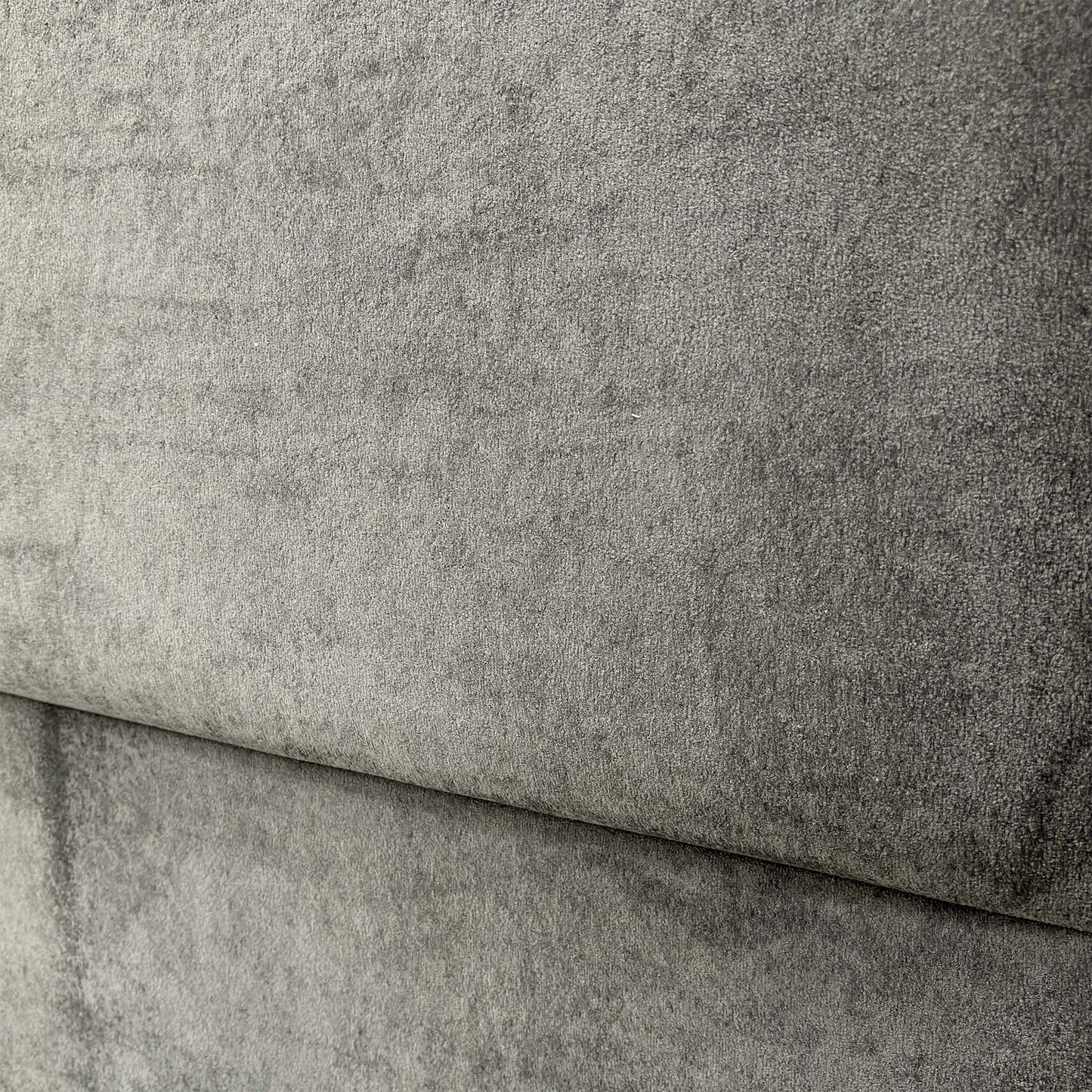 Close-up of the floor-standing headboard, emphasizing the rectangular design and the detailed texture of the Domino velvet fabric.