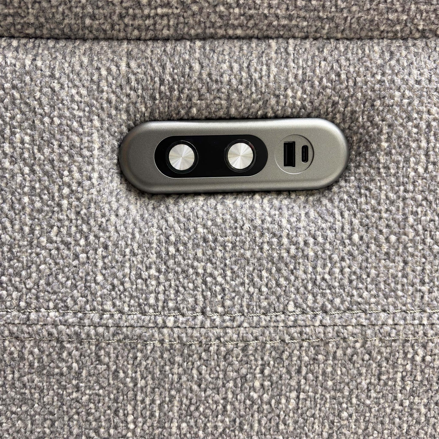 Detailed shot of the integrated USB charging port and the electric recliner control buttons.