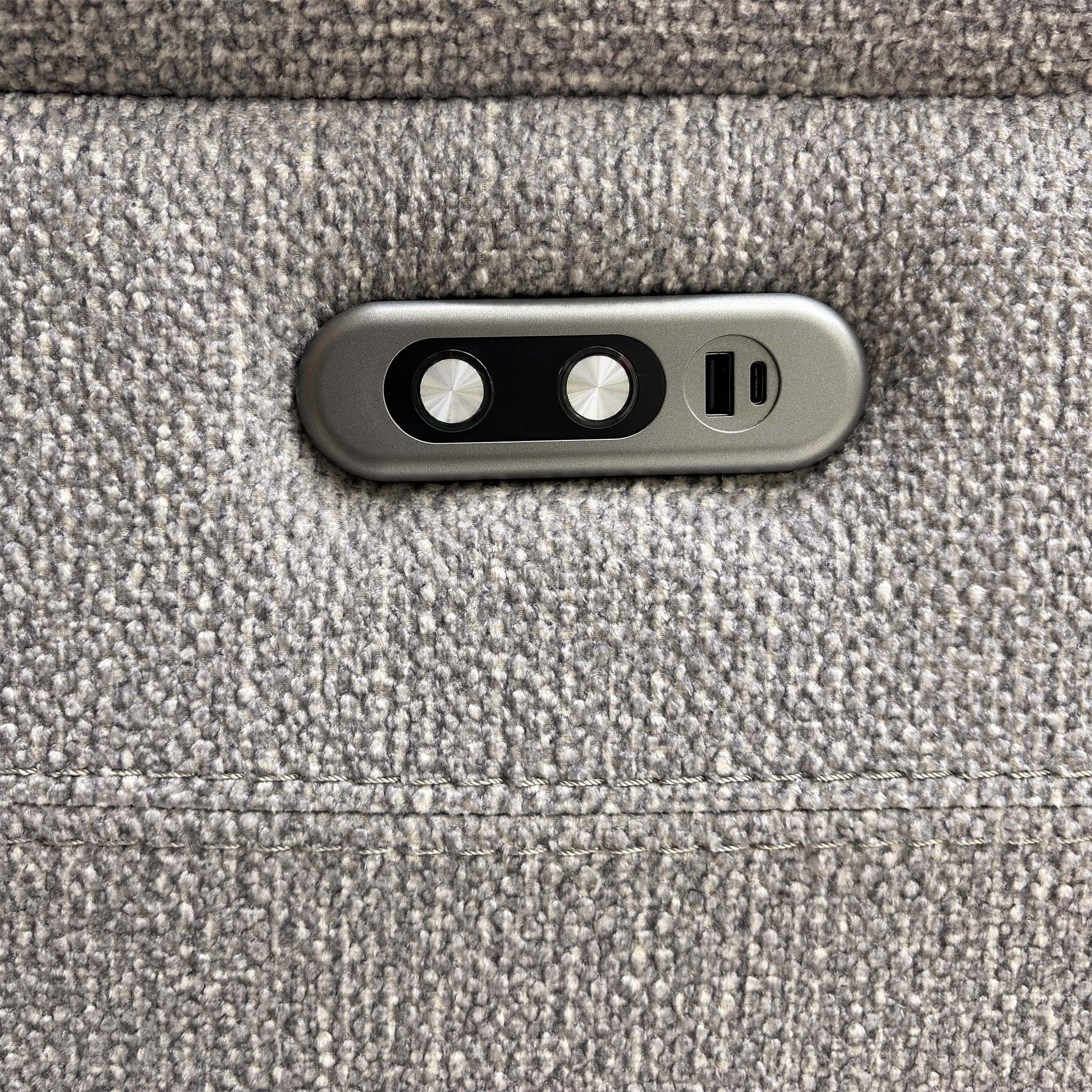 Detailed shot of the integrated USB charging port and the electric recliner control buttons.