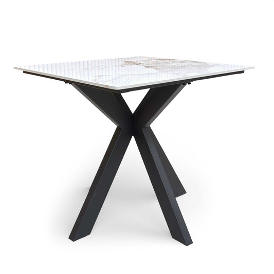 Full view of the 'Kyoto' 80cm square dining table, showing the bright white marble effect top and slim black legs.