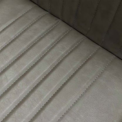 Close-up of the grey faux leather upholstery and stitching details on the Arthur dining seat.