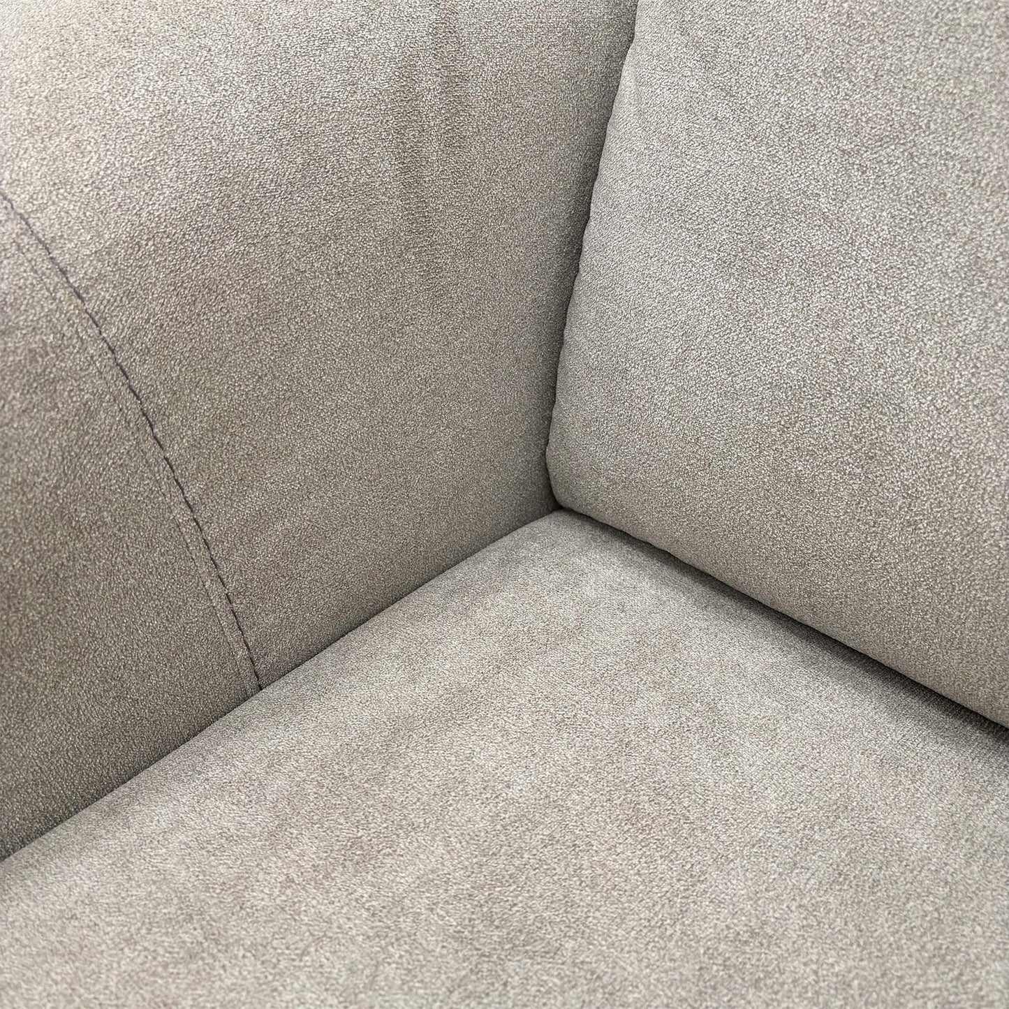 Close-up texture shot of the light grey fabric upholstery, showing the high-quality weave and finish.