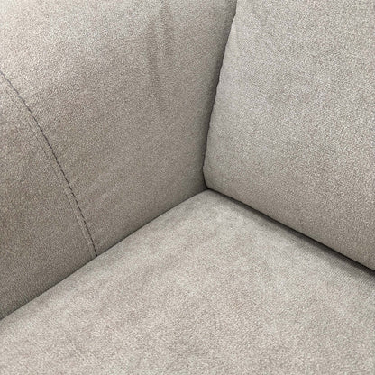 Close-up texture shot of the light grey fabric upholstery, showing the high-quality weave and finish.