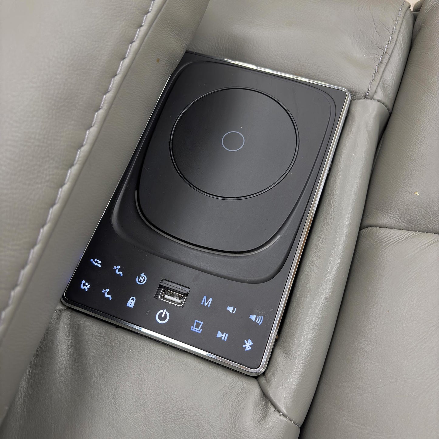 Close-up of the media arm on the 3-seater sofa, showing the Bluetooth control panel and integrated speakers.