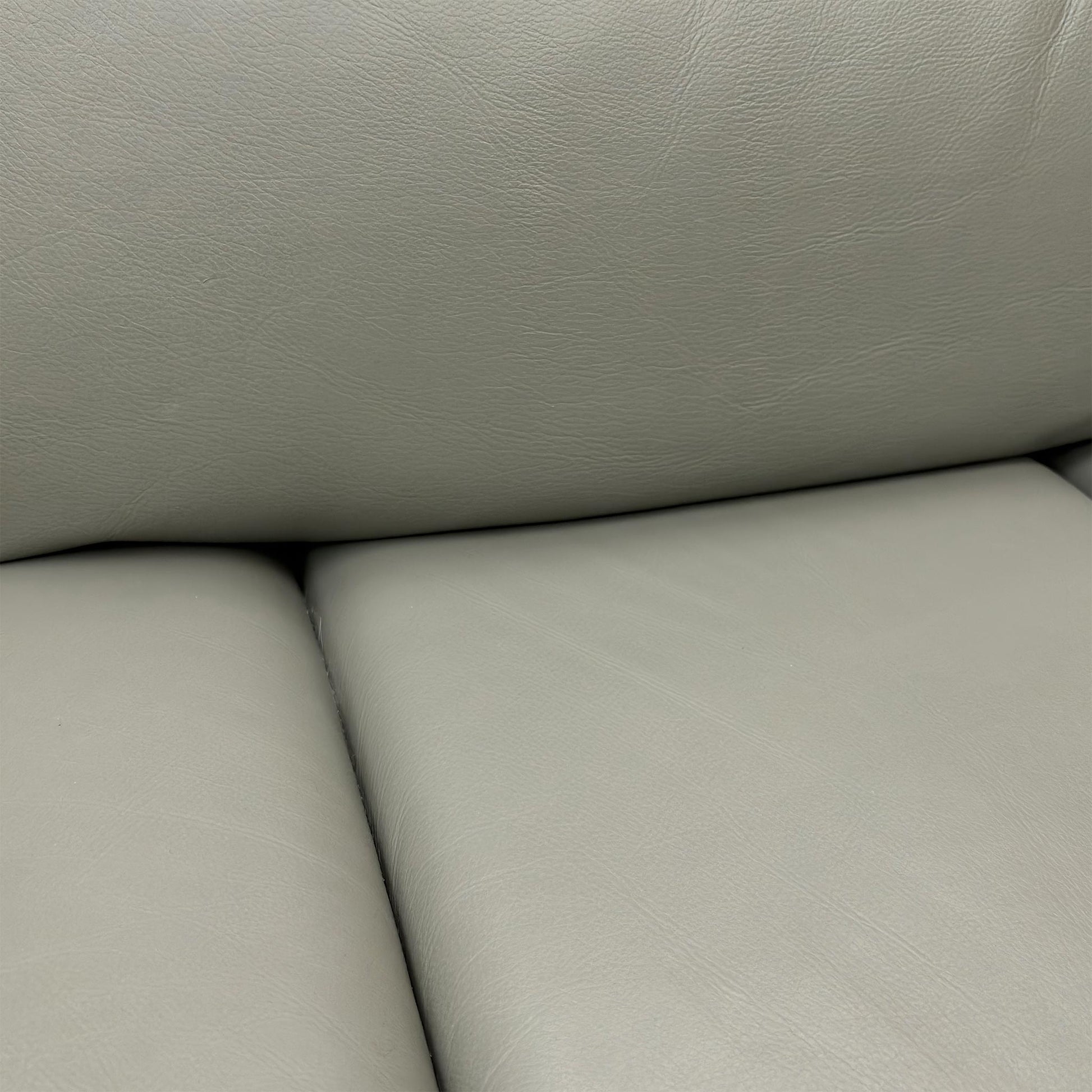 Detailed texture shot of the premium 100% genuine Natural Ash leather upholstery and stitching.