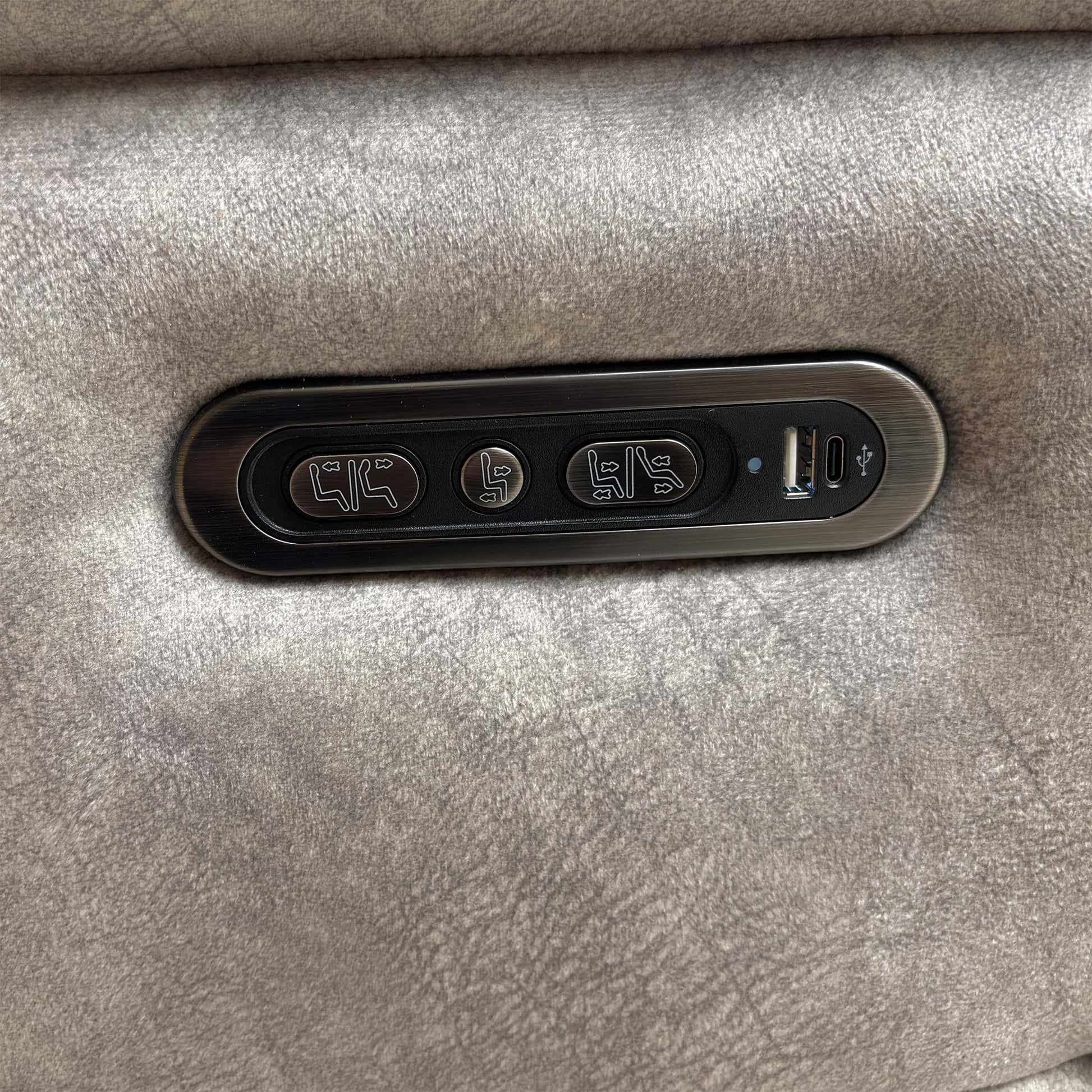View of the side control buttons for the independent power recline and footrest functions.