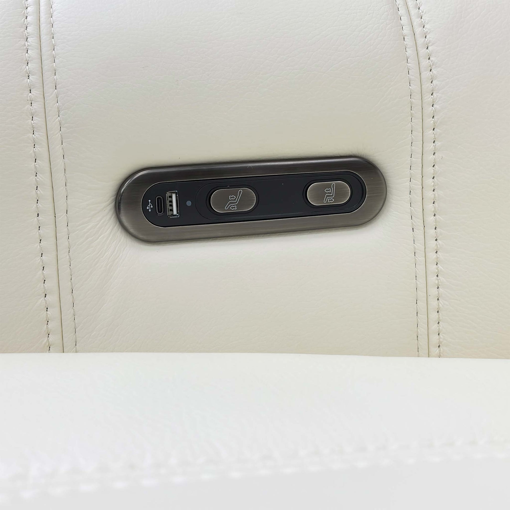 View of the side control buttons for the independent power recline and footrest functions.