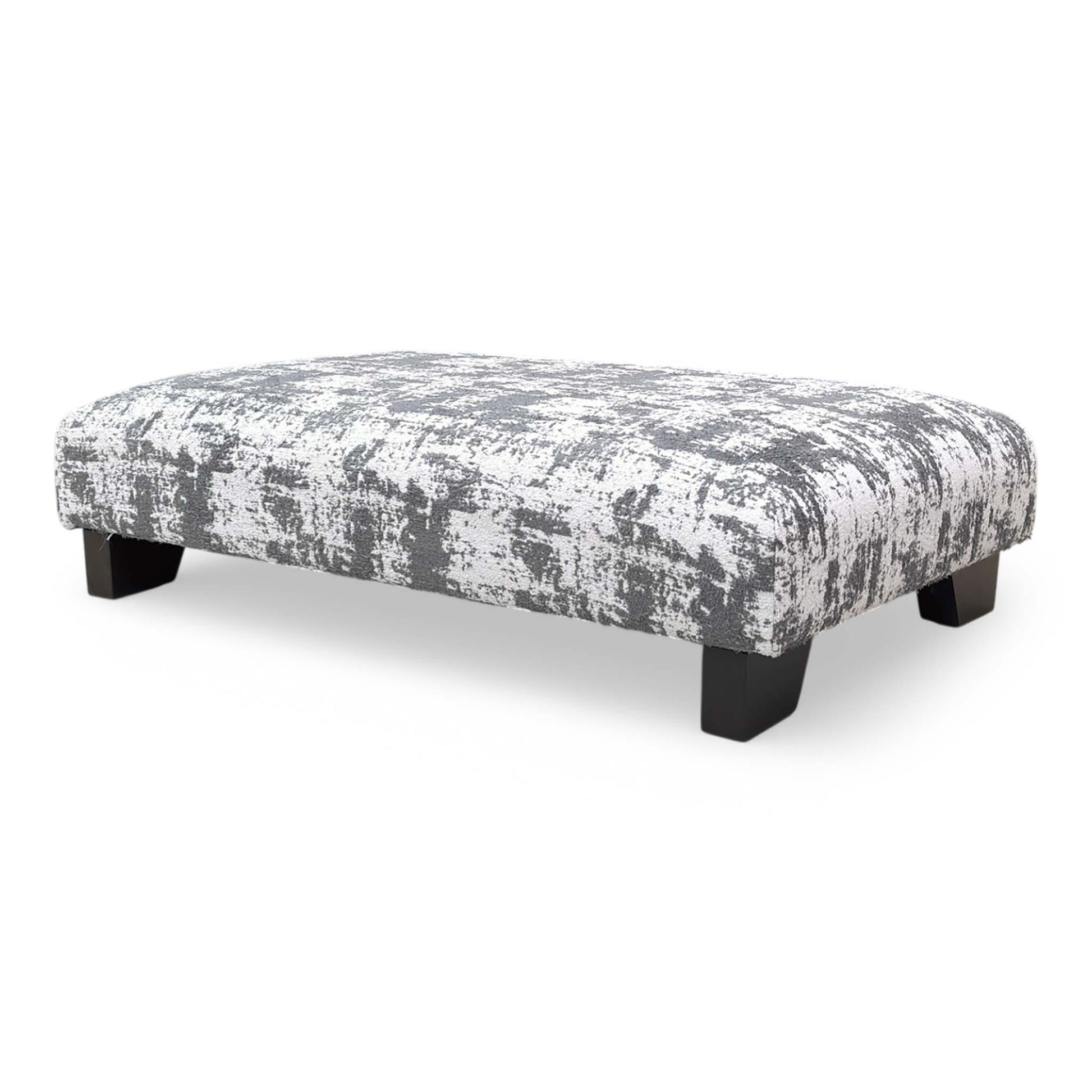 Angle view showing the rectangular silhouette and foam cushioning of the footstool, designed for both comfort and aesthetic appeal.