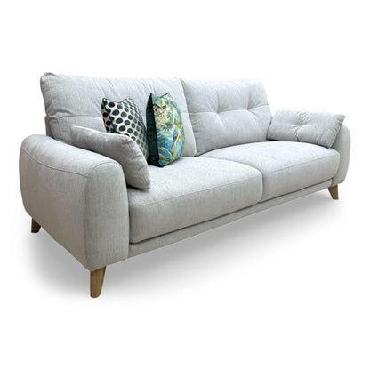 Side view of the sofa, highlighting the clean profile and the inclusion of the arm bolsters.