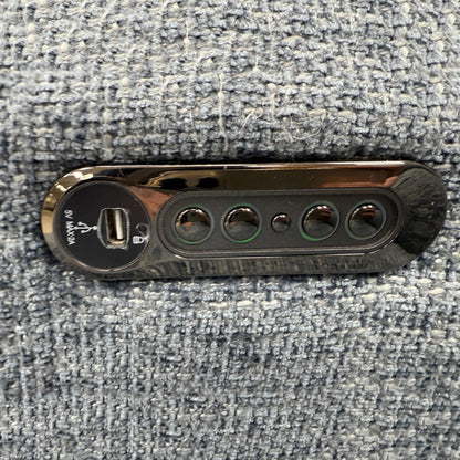 Close-up of the polished metal legs and the contemporary button detailing on the sofa arms.