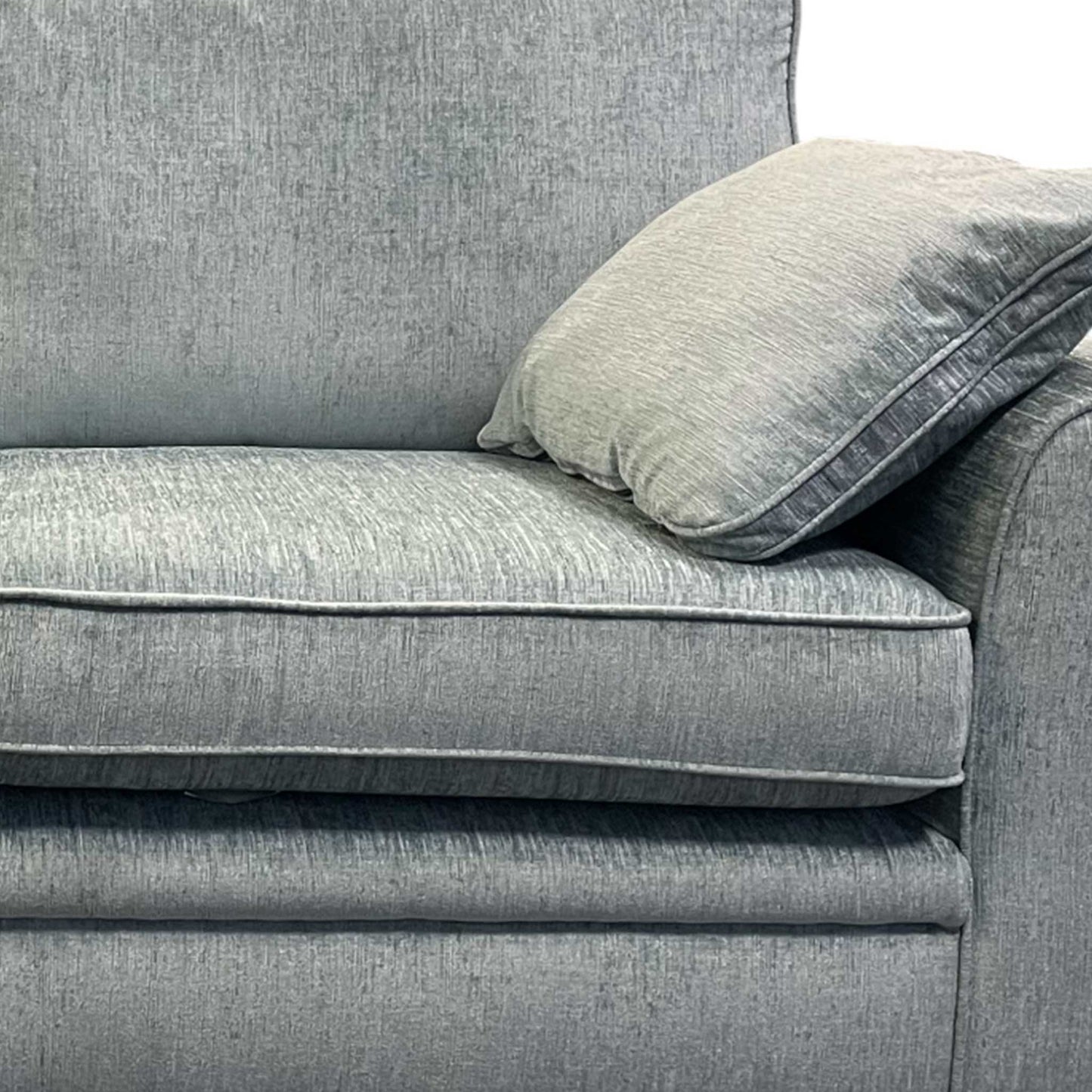 Side profile of the ‘Chalfont’ sofa showcasing the sleek silhouette and wooden frame base.