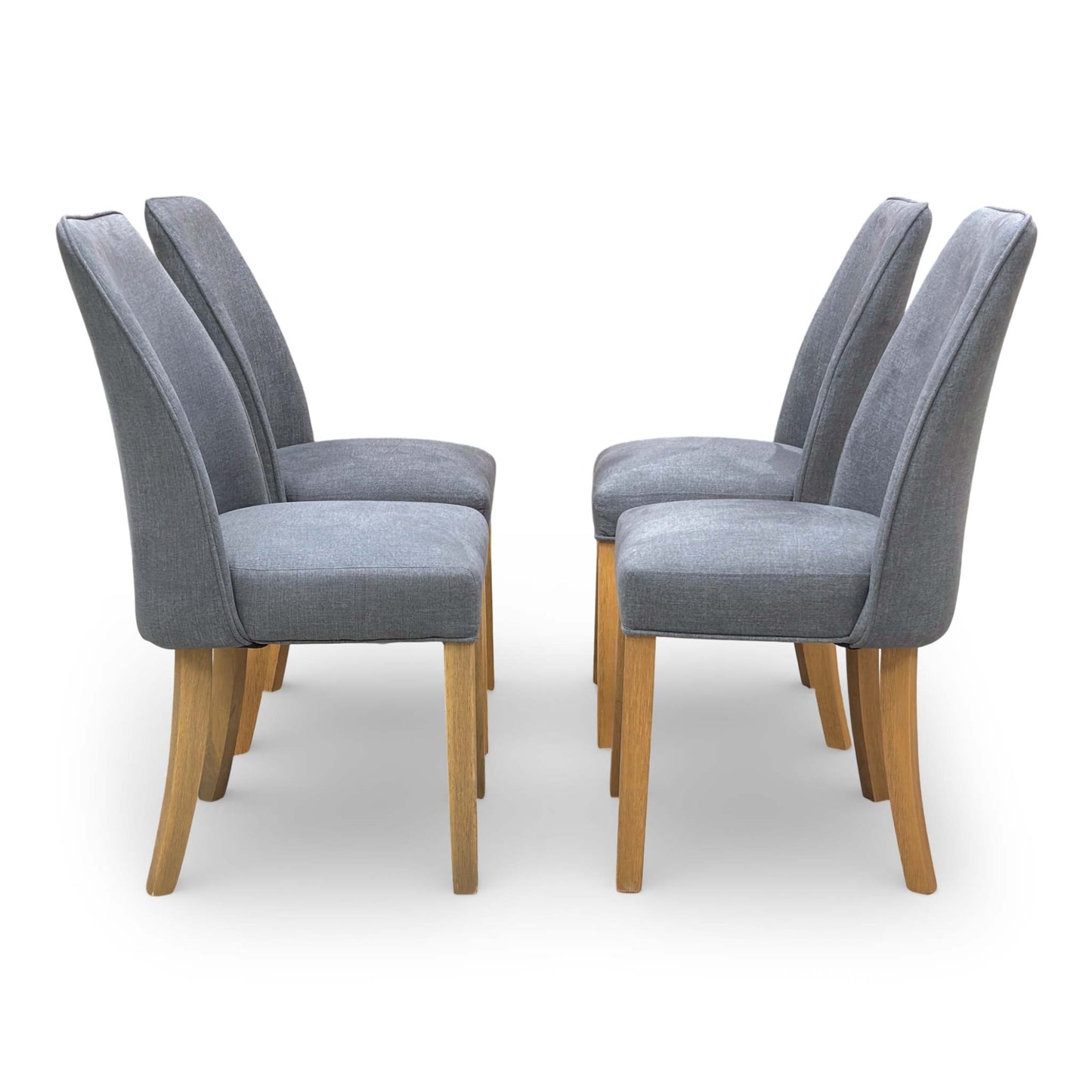 Side view of a Hamilton charcoal grey fabric dining chair featuring a modern silhouette and padded seat.
