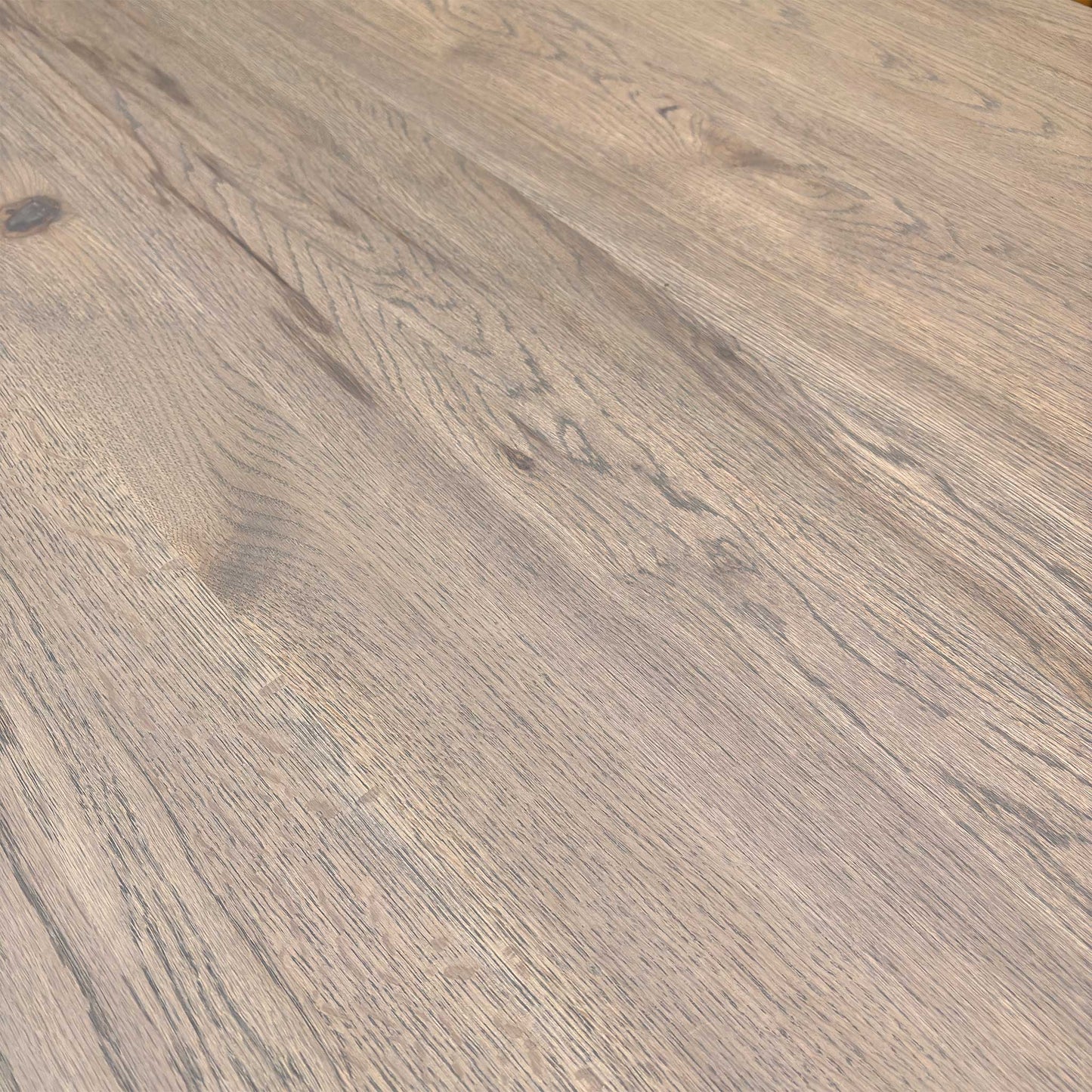 Close-up of vintage grey solid oak tabletop showing natural wood grain, knots, and texture.