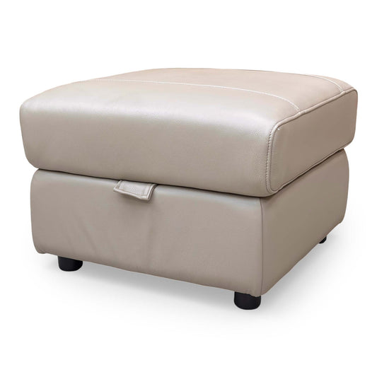 Front view of the Furniture Village ‘Sloane’ Storage Footstool upholstered in Cat-60:06 Barley leather, showcasing its compact rectangular design.