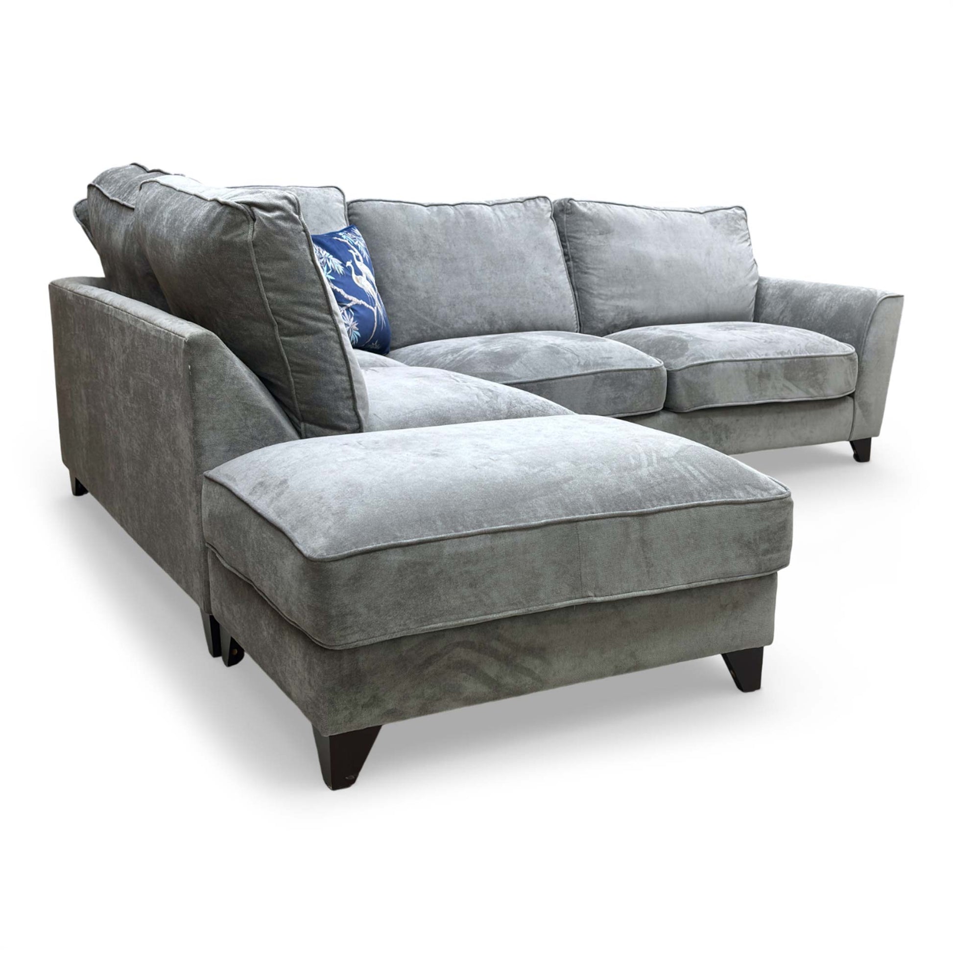 View of the corner sofa with the included large footstool, showing how it can be used to extend the chaise for maximum relaxation.