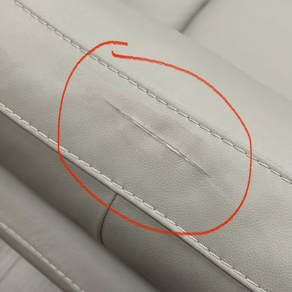 Close-up of the leather upholstery showing a small defect as mentioned in the product description, ensuring full transparency for the buyer.
