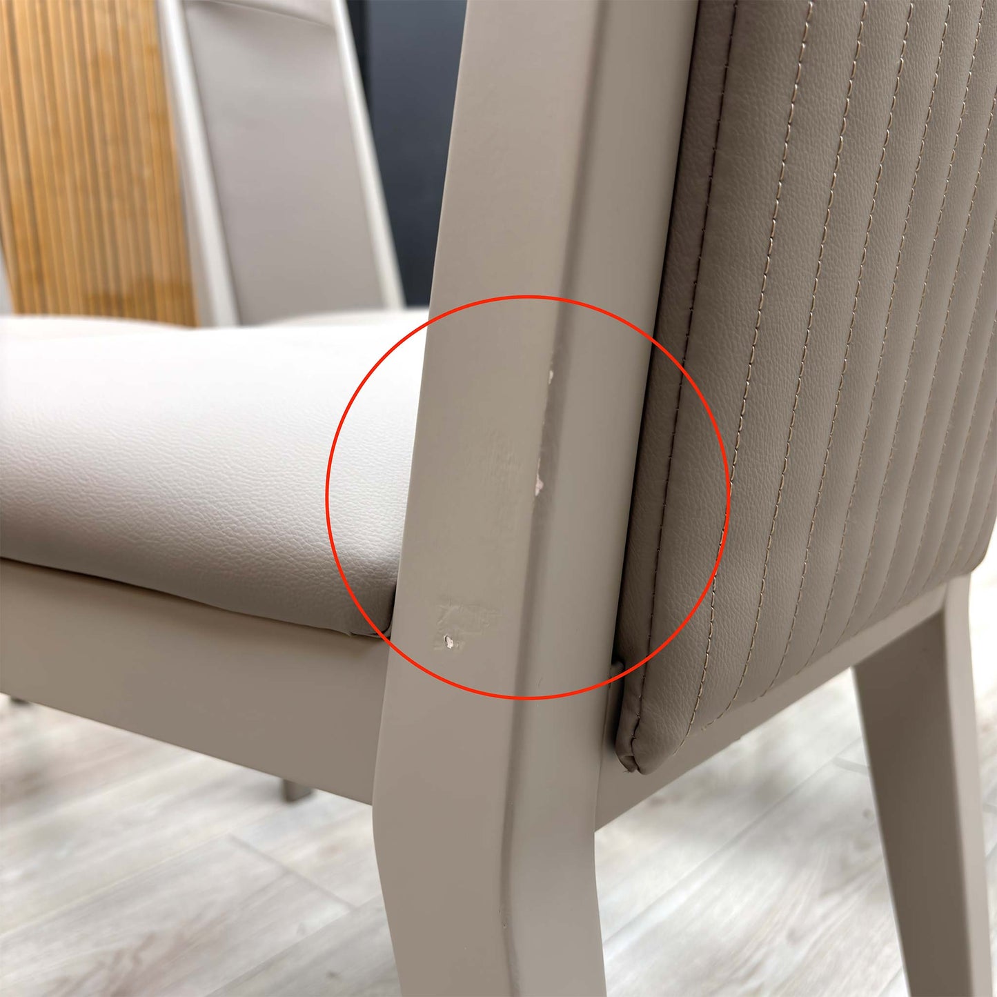 Detail shot of the black powder-coated metal legs, showing the tapered design and the protective feet glides to prevent floor scratching.