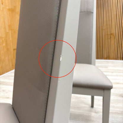 Detail shot of the black powder-coated metal legs, showing the tapered design and the protective feet glides to prevent floor scratching.