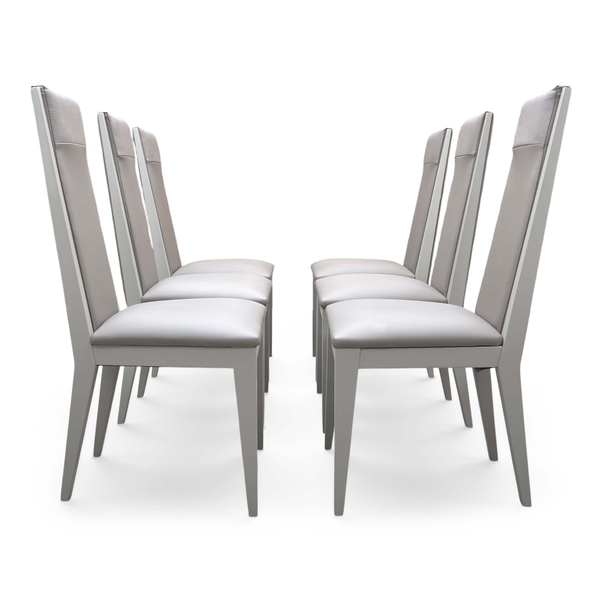 Front view of the ‘Lusso’ Taupe Faux Leather Dining Chairs, demonstrating the material flexibility, seat comfort, and the stability of the metal frame.