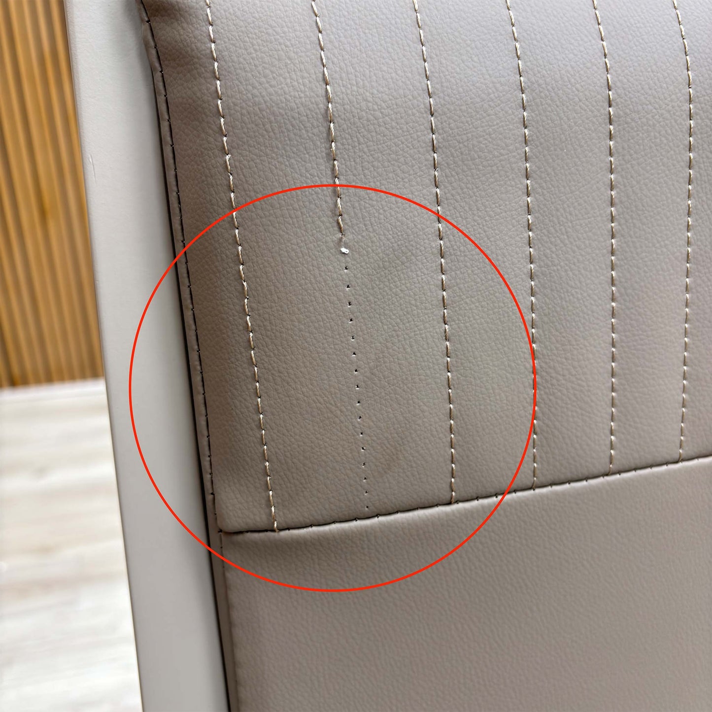 Detail shot of the black powder-coated metal legs, showing the tapered design and the protective feet glides to prevent floor scratching.