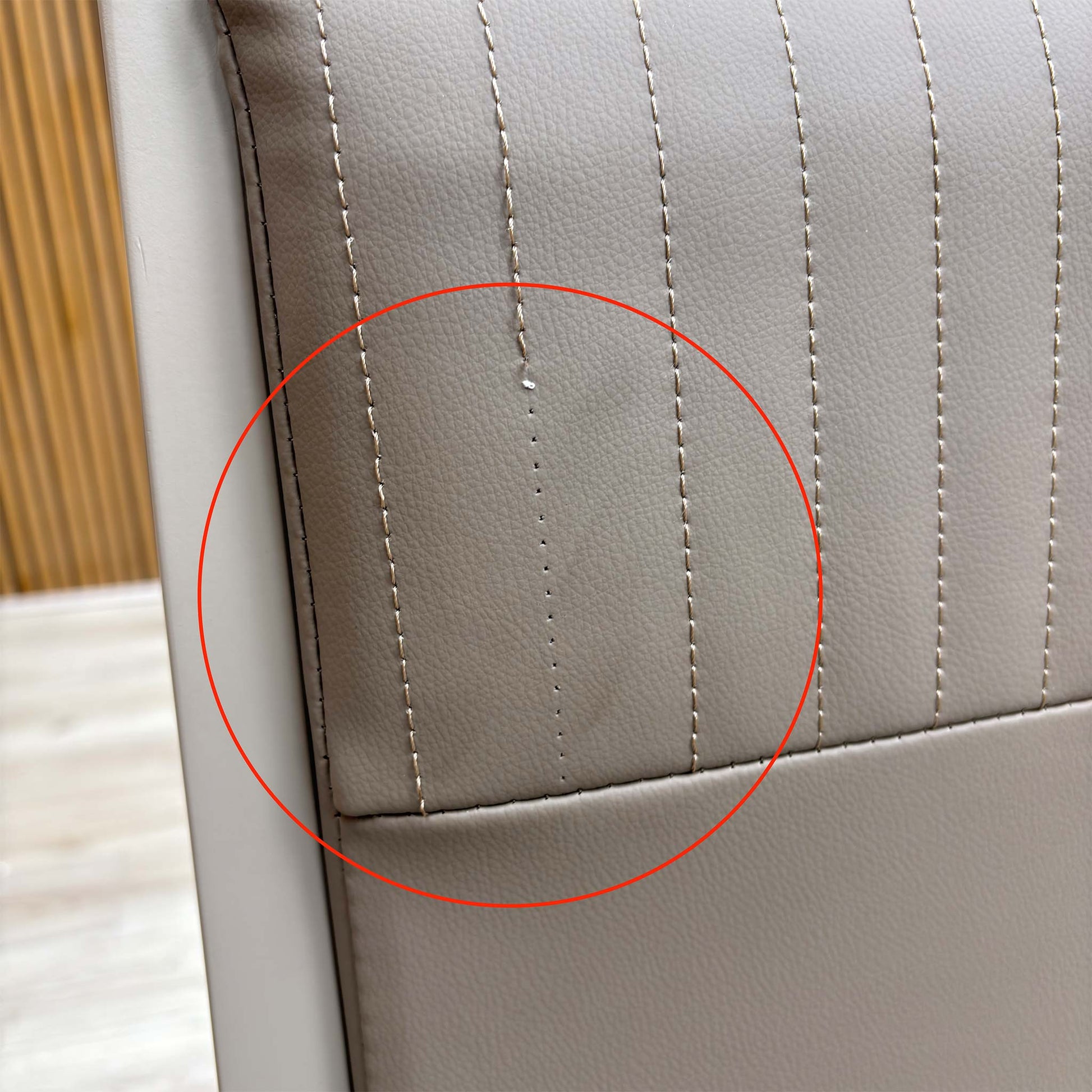 Detail shot of the black powder-coated metal legs, showing the tapered design and the protective feet glides to prevent floor scratching.