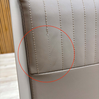 Detail shot of the black powder-coated metal legs, showing the tapered design and the protective feet glides to prevent floor scratching.