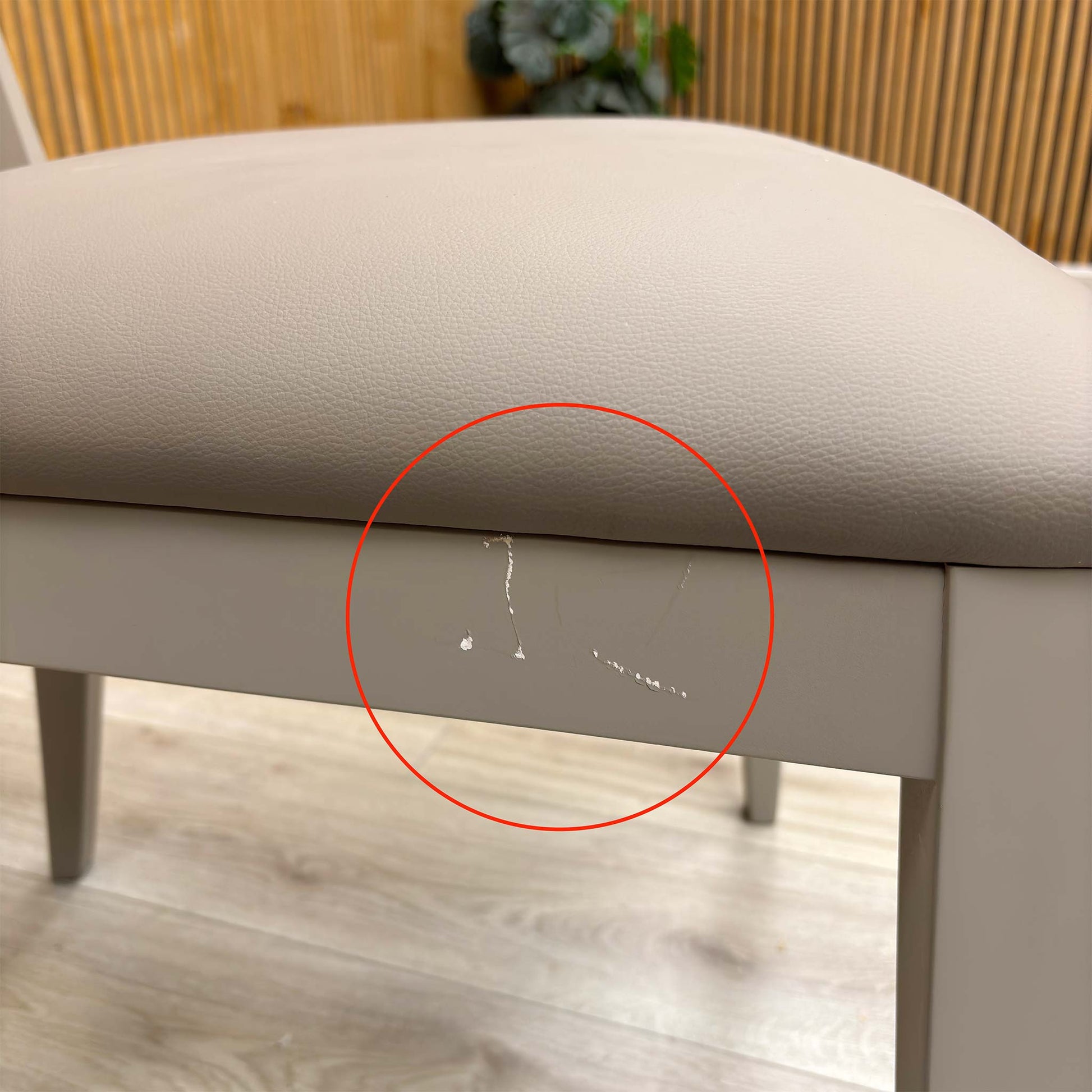 Detail shot of the black powder-coated metal legs, showing the tapered design and the protective feet glides to prevent floor scratching.