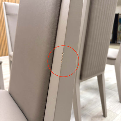 Close-up macro shot of the Taupe faux leather upholstery, highlighting the realistic grain texture and the precise vertical panelled stitching.