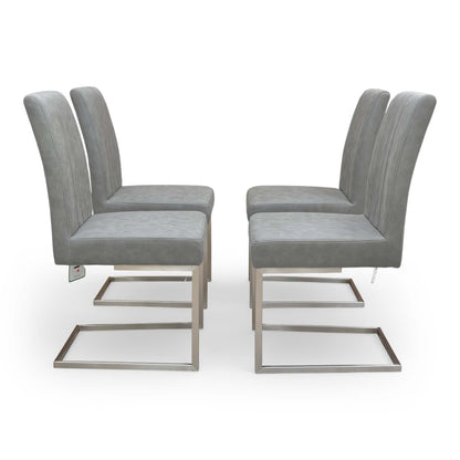 Side profile of the ‘Grigio’ dining chair, showcasing the sleek C-shaped brushed stainless steel frame and elegant silhouette.