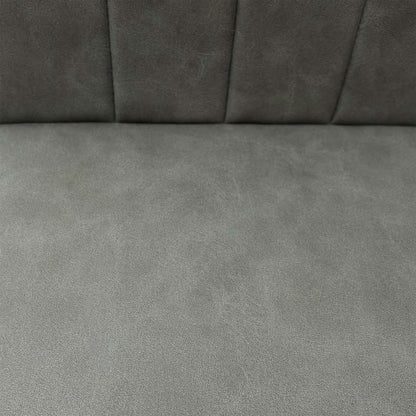 Close-up of the grey faux leather upholstery, emphasizing the foam-cushioned seat and precision vertical stitch detailing.