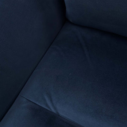 Close-up of the navy blue velvet texture and stitching on the Parker Knoll chair.