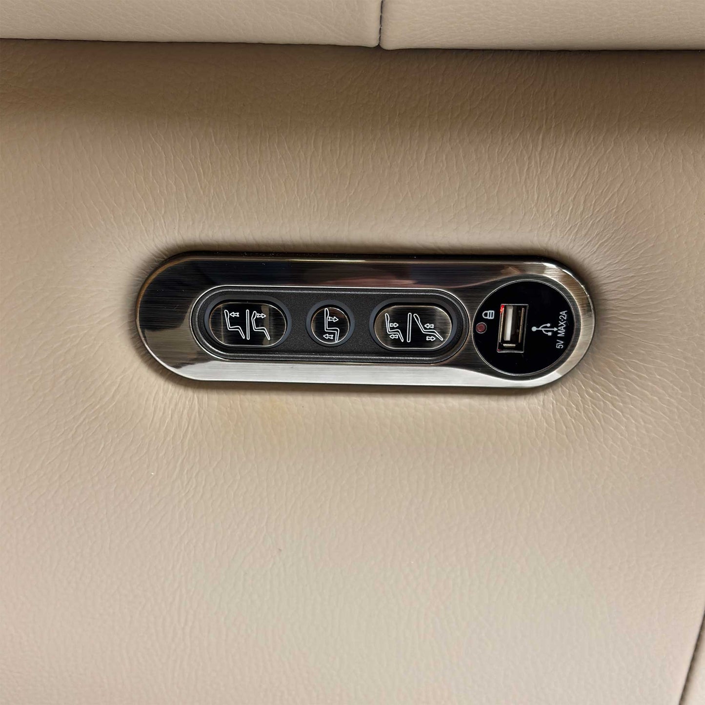 Close-up of the power control panel, illustrating the buttons for the recliner, headrest, and the integrated USB/USB-C charging ports.