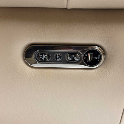 Close-up of the power control panel, illustrating the buttons for the recliner, headrest, and the integrated USB/USB-C charging ports.