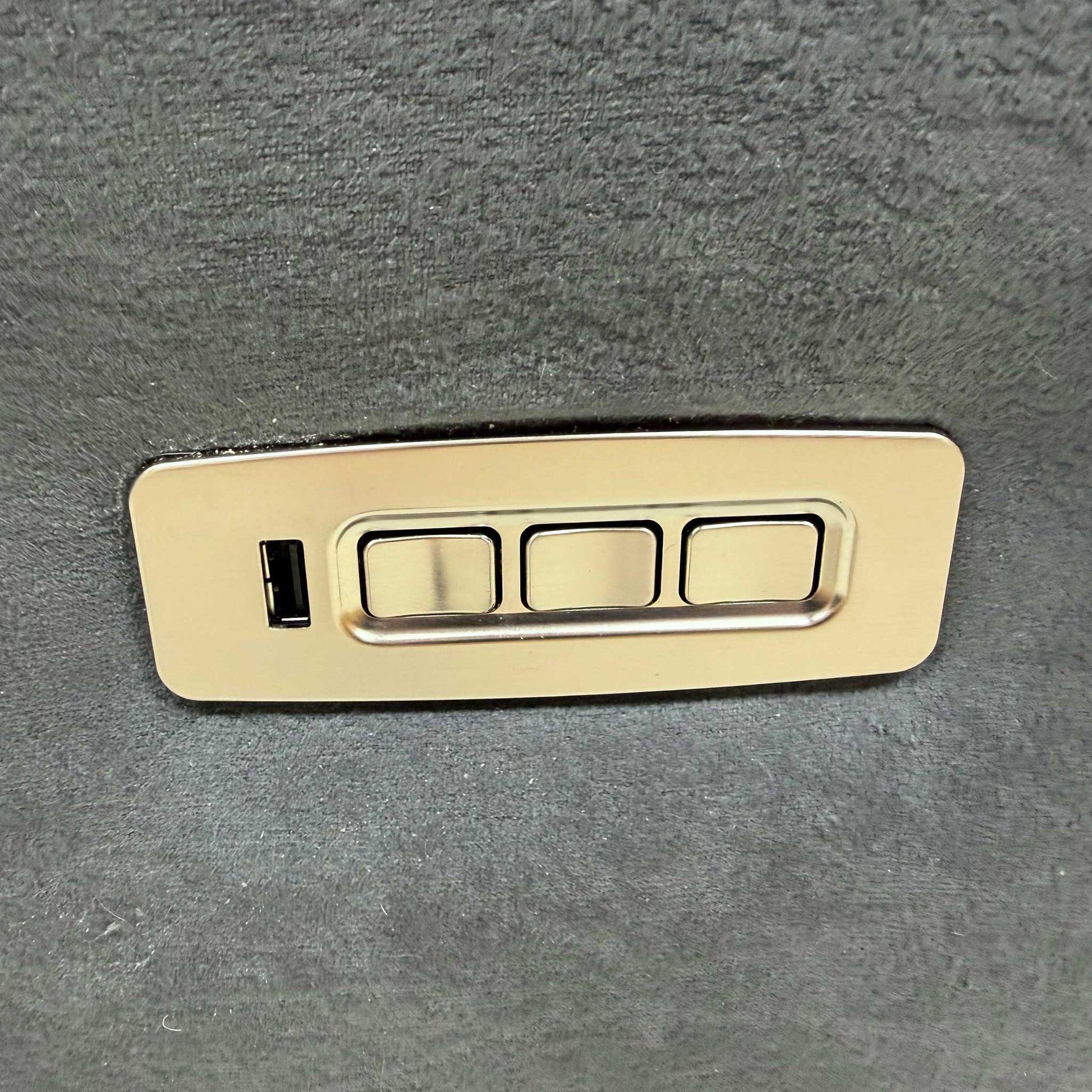 Detailed view of the arm design and control panel for the power headrest, lumbar, and recliner functions.