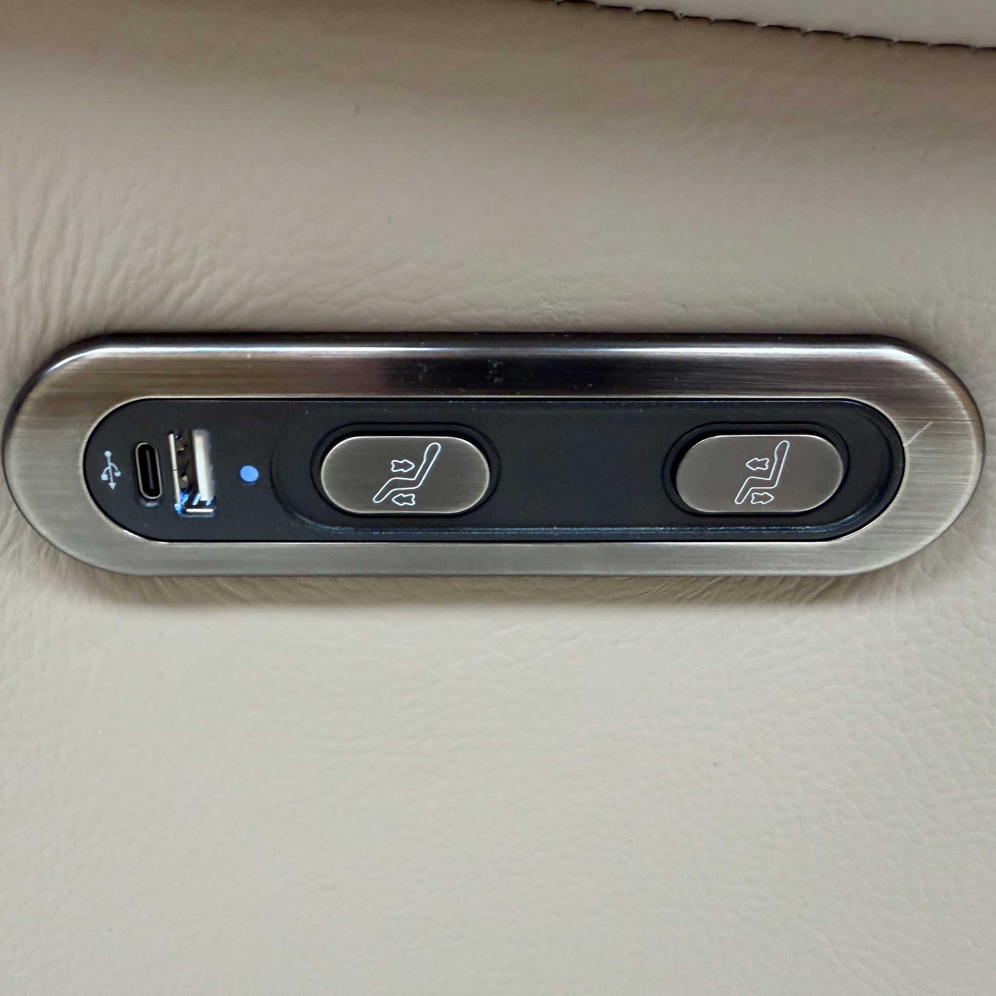 Close-up of the power recliner control button featuring USB and USB-C charging ports and a safety lock.