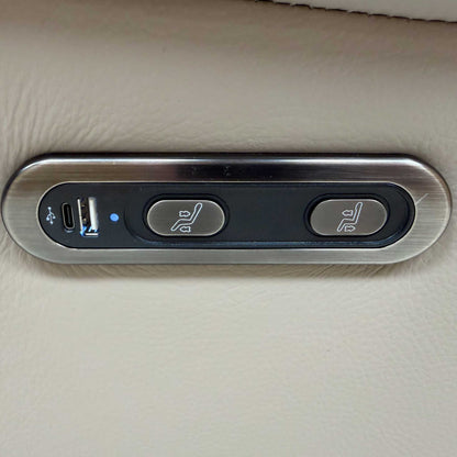 Close-up of the power recliner control button featuring USB and USB-C charging ports and a safety lock.