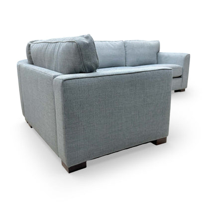 View of the back cushions and formal design of the 'Elora' woven fabric sofa.