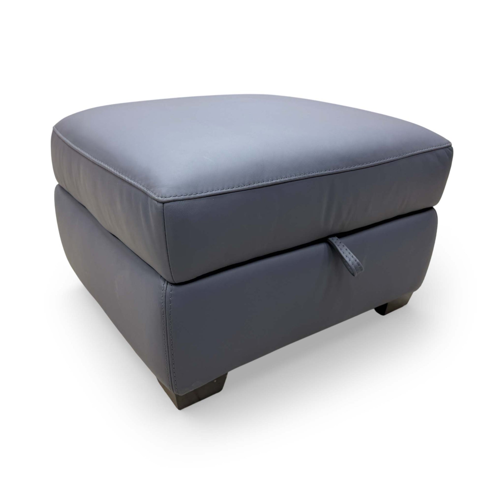 Side profile of the footstool, showing the clean lines and sturdy base of the 'World of Leather' design.