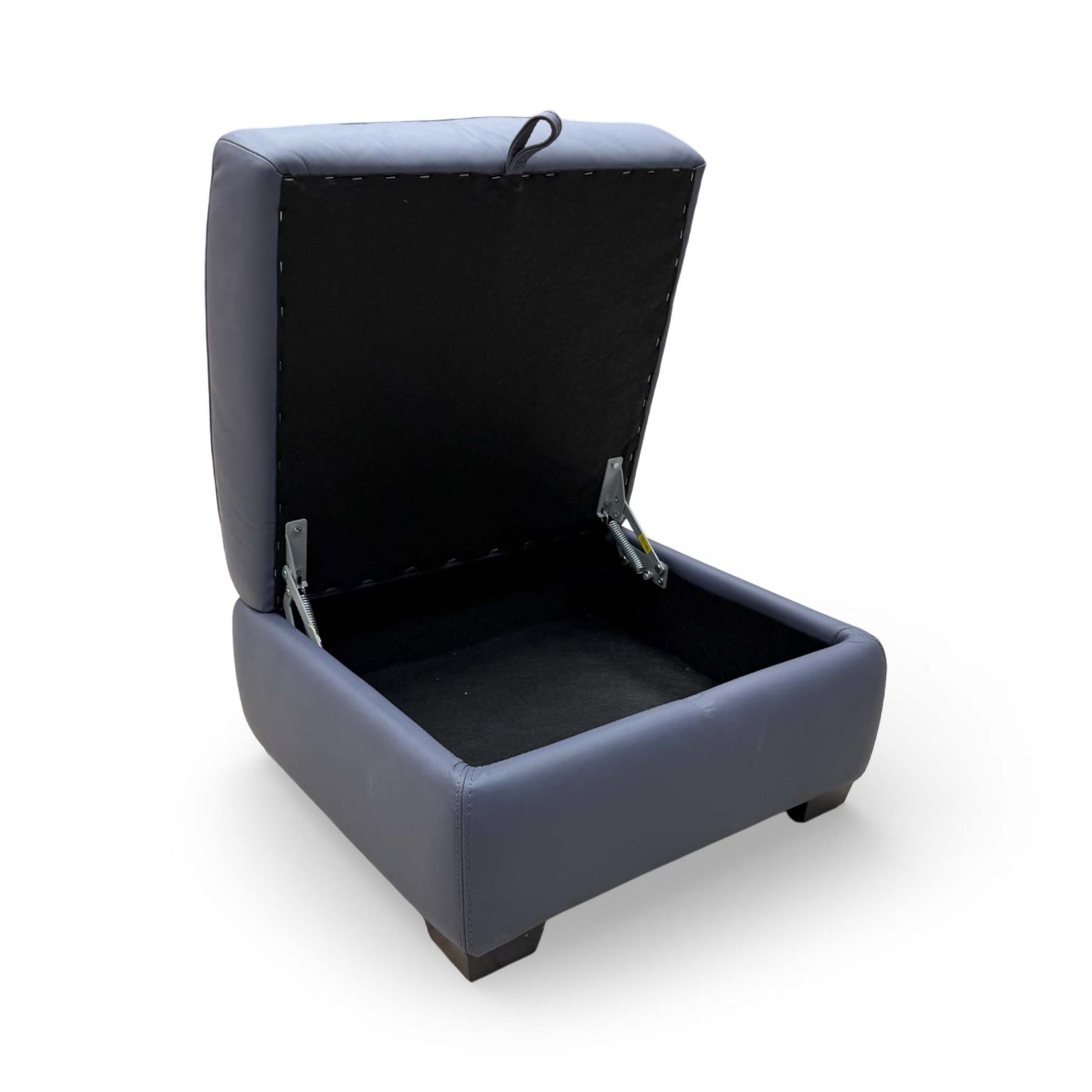 View of the footstool with the lid open, showcasing the hidden internal storage compartment.