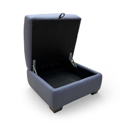 View of the footstool with the lid open, showcasing the hidden internal storage compartment.